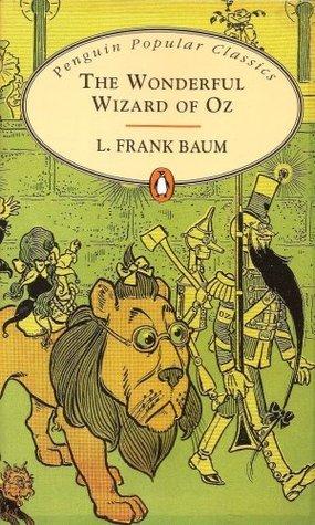 book cover of "The Wonderful Wizard of Oz" featuring the Coward Lion carrying Dorothy on his back walking next to the Tin Man