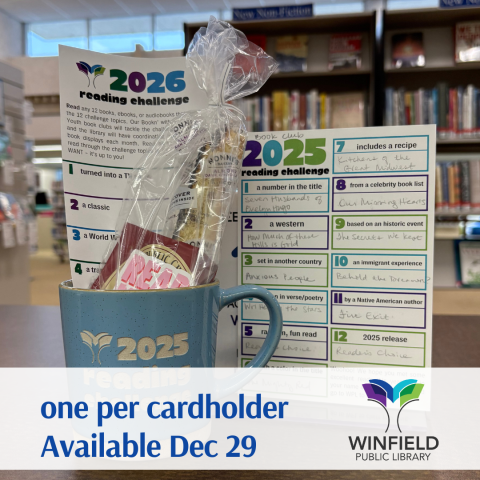 a blue 2025 Reading Challenge mug filled with goodies next to a postcard-sized 2025 Reading Challenge tracking form