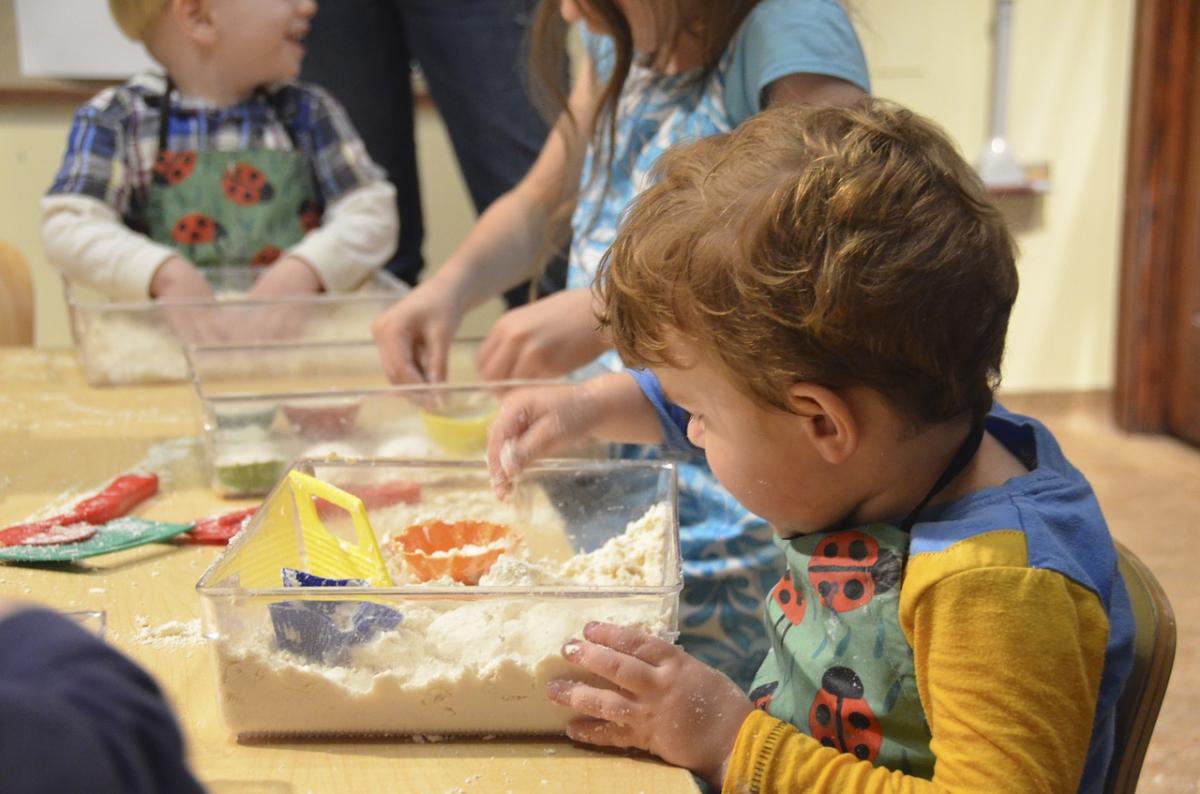 child playing with sensory bin