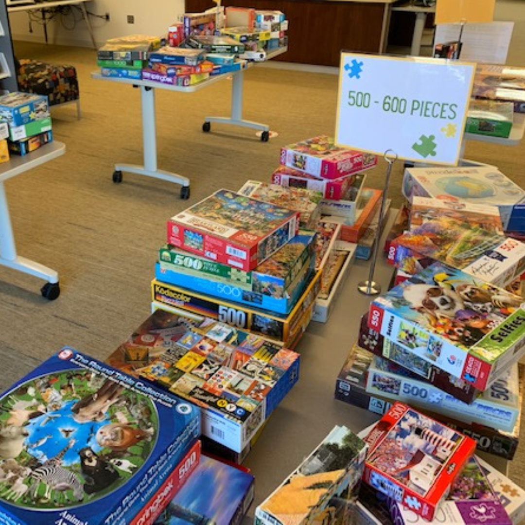 photograph of tables filled with boxed-up jigsaw puzzles